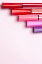 Five markers or pens of pink, purple, pink color lie like steps on a pink background, isolated mock up