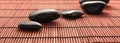 Five massage stones on a bamboo mat Royalty Free Stock Photo