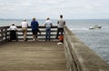 Five Men Fishing on a Pier Royalty Free Stock Photo