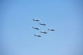 Five military helicopter against the blue sky.