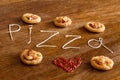 Five mini pizzas and written text 