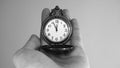 Five minutes to twelve o`clock. Old pocket watch in young woman`s hand. Black and white photo.  Copy space for advertising Royalty Free Stock Photo