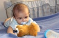 Five months old baby boy playing on the bed Royalty Free Stock Photo