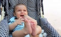 Five months old baby boy playing in the pushchair Royalty Free Stock Photo