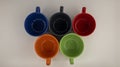 Five multi-colored Olympic-style mugs on a white background Royalty Free Stock Photo