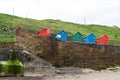 Five multi-coloured beach huts on Whitby West Cliff, Whitby, North Yorkshire Royalty Free Stock Photo