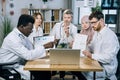 Multi ethnic doctors having video chat on modern laptop Royalty Free Stock Photo