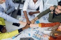 Five multi ethnic students bumping with fists at office