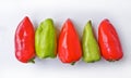 Five multicolored bell peppers isolated