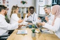 Five multiethnic healthcare workers sharing with knowledges during meeting Royalty Free Stock Photo