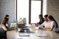 Five multiracial coworkers having busy working day at coworking room