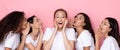 Five Multiracial Female Friends Sharing Exciting News Over Pink Background