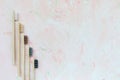 Five natural wooden bamboo toothbrushes on pink