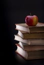 Five old books with an apple Royalty Free Stock Photo