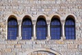Five old windows with arches, columns and lattices on a stone wa Royalty Free Stock Photo