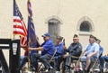 Five older men in a float in a parade in small town America