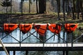 five orange lifejackets hang on the railing near the pier at the boat station. Gatchina, Russia.