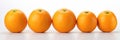 Five Oranges Lined Up In A Row On A White Background