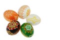 Five ornamental home made hand painted easter eggs placed in circle creating flower shape, white background.