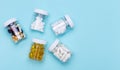 Five packs with various pills on a blue background. Health concept. Royalty Free Stock Photo