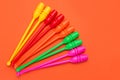 Five pairs of colored gymnastic clubs, lie on an orange background, concept