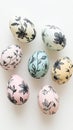 Five pastel eggs with black floral patterns, white background, text Royalty Free Stock Photo