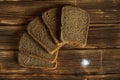 Five pieces of black bread and salt on a wooden surface Royalty Free Stock Photo