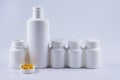 Five pills bottles on white background with copy space for text. Pharmaceutical product container.