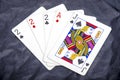 Five playing card`s a hand of a three of a kind two`s and a ace and a jack