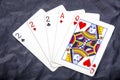 Five playing card`s a hand of a three of a kind two`s and a ace and a queen Royalty Free Stock Photo