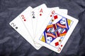 Five playing card`s a hand of a three of a kind two`s and a ace and a queen Royalty Free Stock Photo