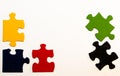 Five primary-colored hand-painted pieces of a jigsaw puzzle