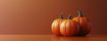 Five Pumpkins Resting On An Orange Surface Royalty Free Stock Photo