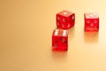 Five red dice on golden background