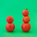 Five red tomatoes in stacks on cyan green isolated background Royalty Free Stock Photo