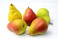 Five ripe juicy pears on a white wooden background. Close-up Royalty Free Stock Photo