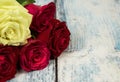 Five roses on a background of a wooden tabletop in a vintage st