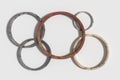 Five rusty Olympic circles on white background