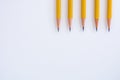 Five Sharpened Pencil Tips Pointing Down on White Background Royalty Free Stock Photo
