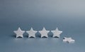 Five silver stars, one star fell. Loss of rating and level, reducing prestige and reputation. Rating and status of the restaurant Royalty Free Stock Photo