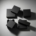 Five small, black square boxes arranged on a gray surface. Four of the boxes have their lids Royalty Free Stock Photo