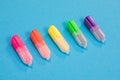 Five small multicolored highlighters on azure background isolated
