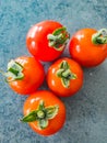Five small red tomatoes on a grey background Royalty Free Stock Photo