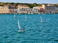 Five small sailboats for one at sea near the coast of Menorca