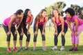 Five smiling runners supporting breast cancer marathon