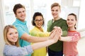 Five smiling students giving high five at school Royalty Free Stock Photo