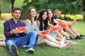 Five smiling women and men with slices of watermelon outdoors Royalty Free Stock Photo