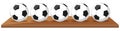 Five soccer balls on wooden board Royalty Free Stock Photo