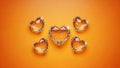 Five Sparkling Heart-Shaped Gems on Orange Background Royalty Free Stock Photo