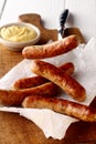 Five spicy grilled sausages with mustard dip